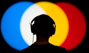 A listener takes in Susan Hillers Magic Lantern piece